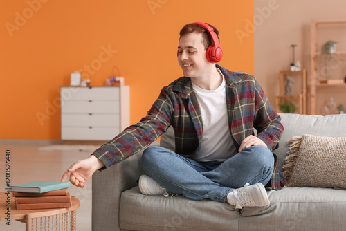 Young man listening to audi...