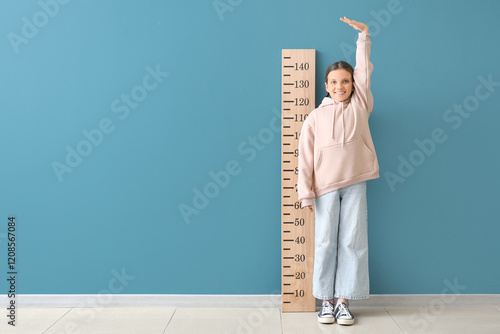 Cute girl measuring height ...