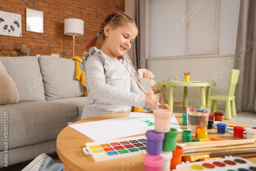 Little girl painting with b...