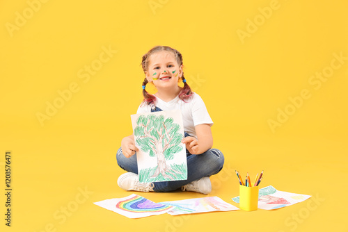 Little girl with drawings s...