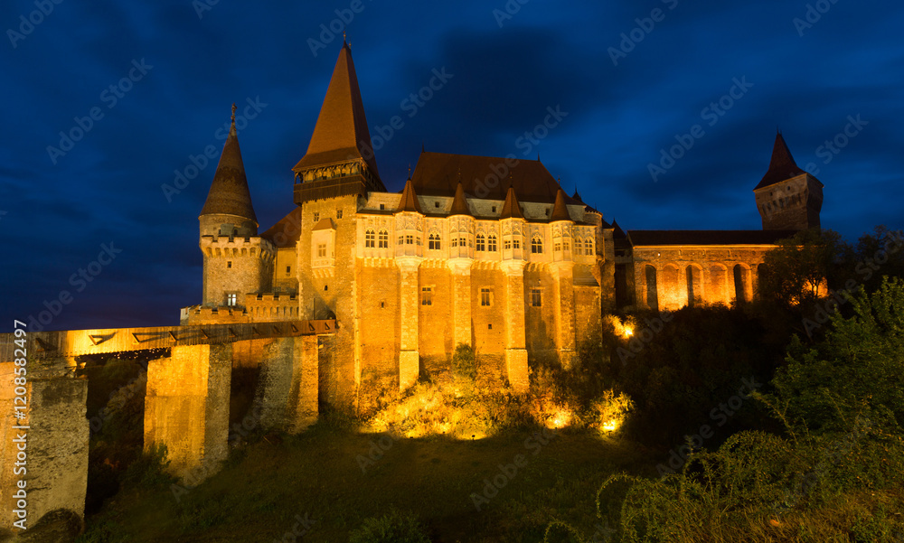 Fototapeta premium Corvin Castle is on the green mountain in night of Romania.