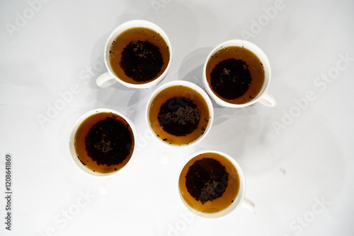 Five white cups of black tea