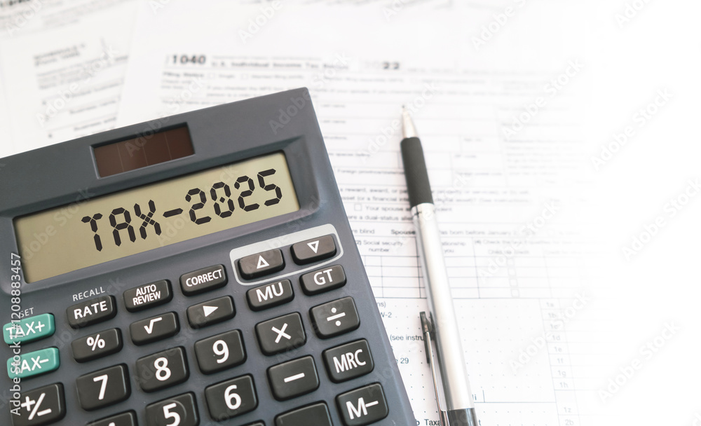 Text Tax 2025 on the calculator and taxes documents. Business and Annual tax concept. Text Tax 2025 on the calculator and taxes documents. Business and Annual tax concept.