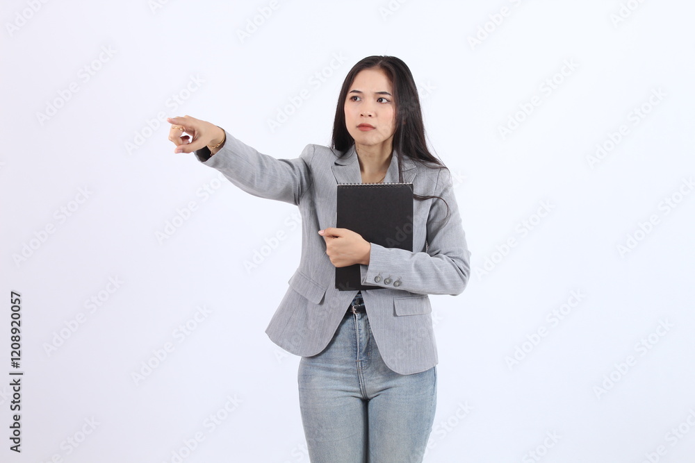 Woman in a gray blazer points to asides with hugging a book in her hand Business asian woman Woman in a gray blazer points to asides with hugging a book in her hand Business asian woman