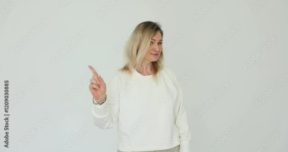 Woman confidently showing refusal hand gesture and shaking head on white background Woman confidently showing refusal hand gesture and shaking head on white background