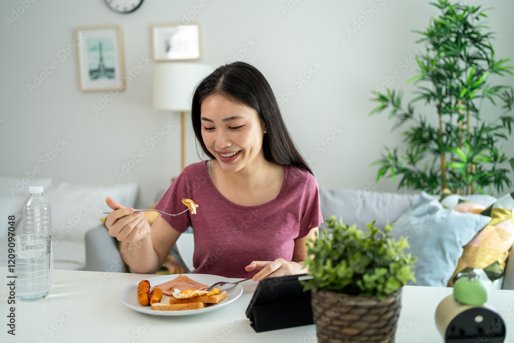 Asian young woman eating American Breakfast in living room at home. Asian young woman eating American Breakfast in living room at home.