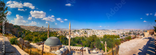 Sanliurfa panorama view old town city as view from castle, Urfa,Turkey. Halil Ur-Rahman Mosque is middle. Blue sky and clouds. Green trees and old city summer.Best touristic muslim destination Turkiye photo