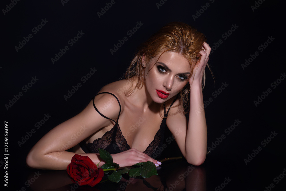 Naklejka premium Seductive woman holding red rose. Slim sexy beautiful woman with naked shoulder hold red roses, isolated on studio background. Portrait of sensual girl with flowers.