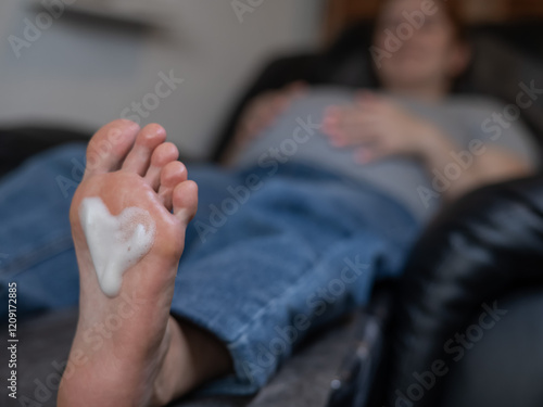 Pregnant woman on a hardware pedicure procedure in a beauty salon.  photo