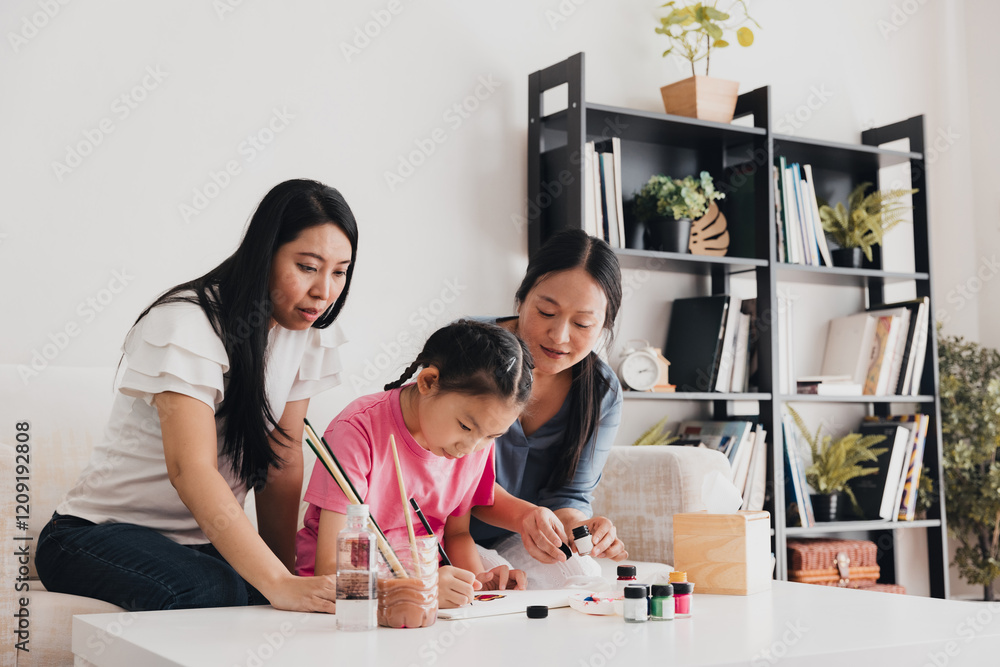 LGBTQ couple engaging in art activities with their daughter at home LGBTQ couple engaging in art activities with their daughter at home