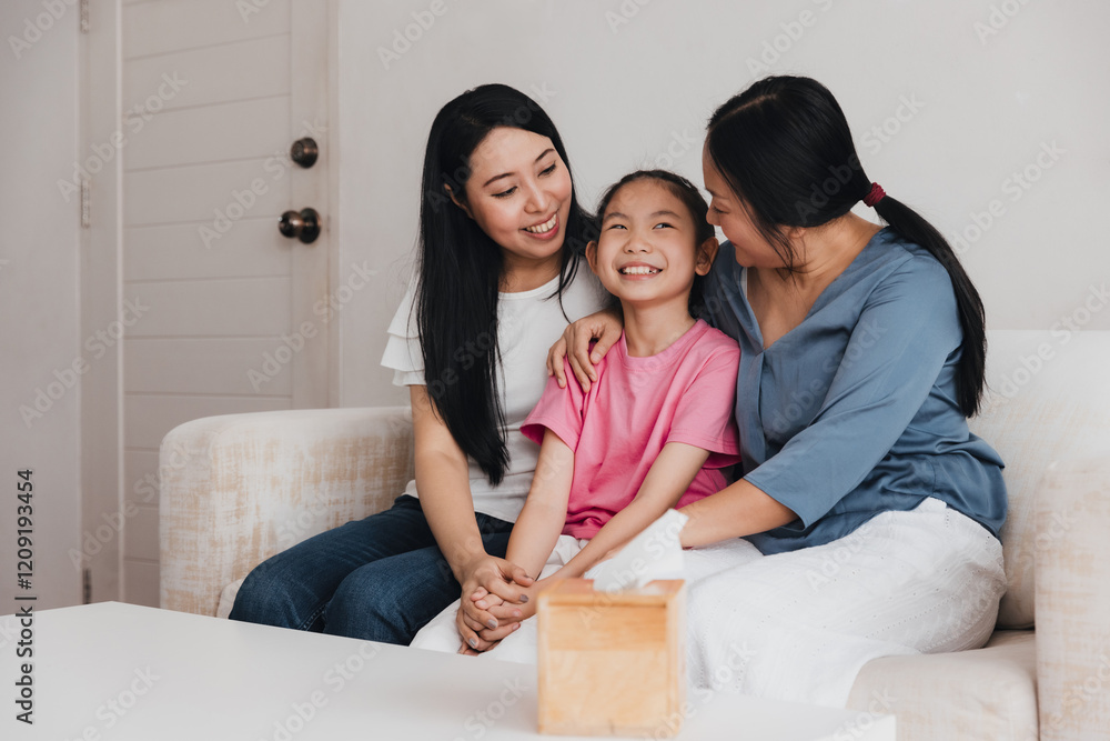 Family celebrates love and joy in home adoption moment between two mothers and their daughter Family celebrates love and joy in home adoption moment between two mothers and their daughter