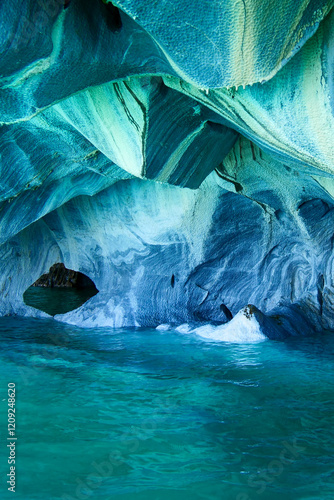 Vertical image of Sculpted blue chapels of Marble caves or Cuevas de Marmol at turquoise General Carrera Lake. Location Puerto Sanchez, Chile photo