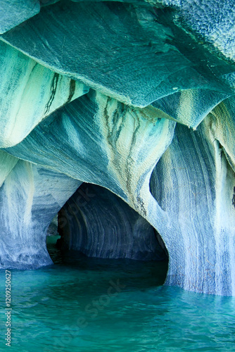 Vertical image of Sculpted blue chapels of Marble caves or Cuevas de Marmol at turquoise General Carrera Lake. Location Puerto Sanchez, Chile photo