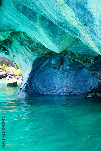 Vertical image of Sculpted blue chapels of Marble caves or Cuevas de Marmol at turquoise General Carrera Lake. Location Puerto Sanchez, Chile