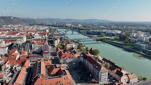Amazing panoramic video of Maribor old town with bridges and beautiful red roofed houses along Drava river in Slovenia