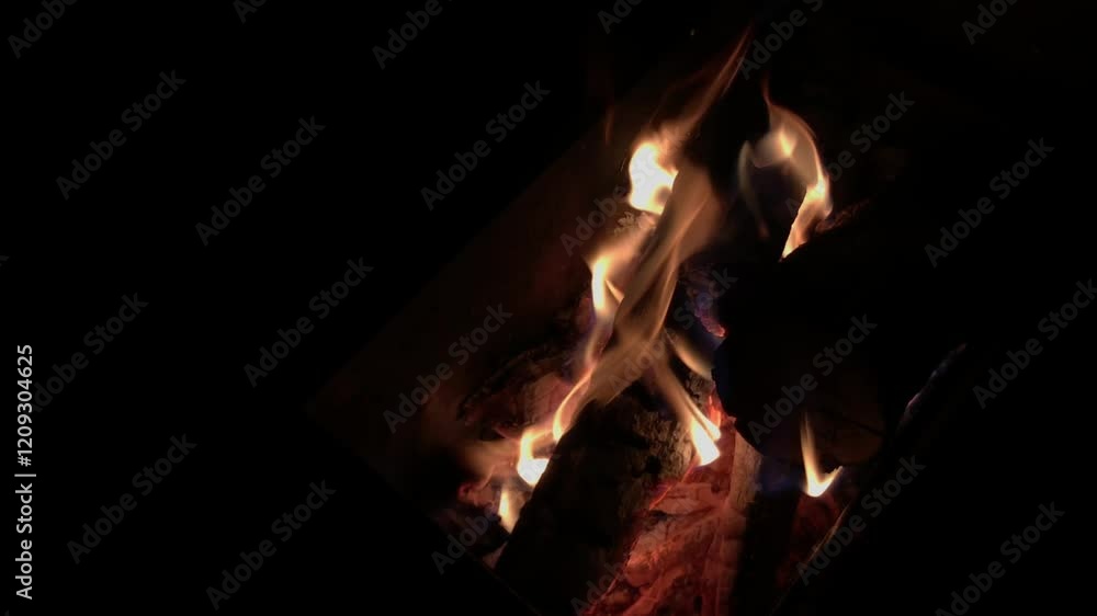 A warm fire burning brightly in a fireplace at night. 4k video footage A warm fire burning brightly in a fireplace at night. 4k video footage