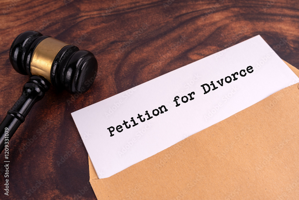 Document with Petition For Divorce words on it. With judge gavel on wooden background Document with Petition For Divorce words on it. With judge gavel on wooden background