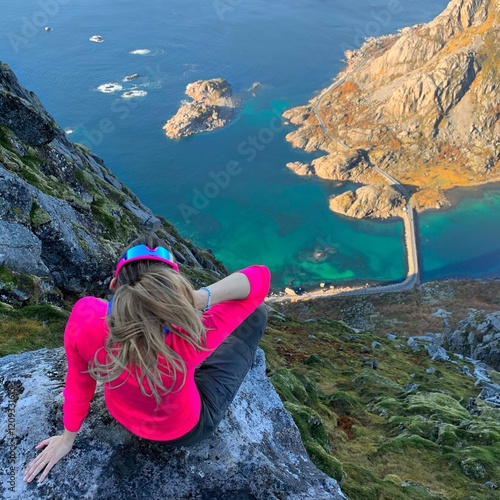 girl on a rock in the mountains with sea view