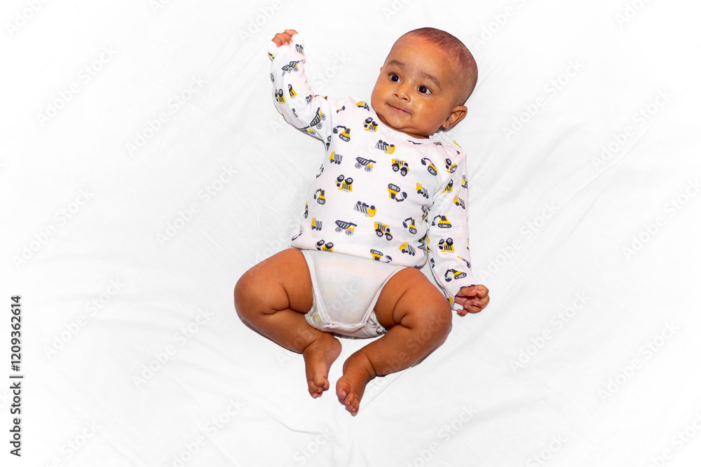 Portrait of a smiling three-month-old baby lying down wearing a white swipe shirt and diapers against a white background. Portrait of a smiling three-month-old baby lying down wearing a white swipe shirt and diapers against a white background.