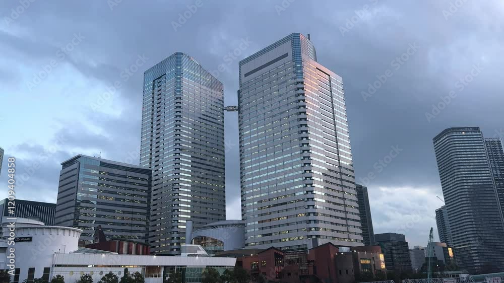 Modern twin skyscrapers in Harumi, Tokyo, with a bridge connecting the towers at dusk Modern twin skyscrapers in Harumi, Tokyo, with a bridge connecting the towers at dusk