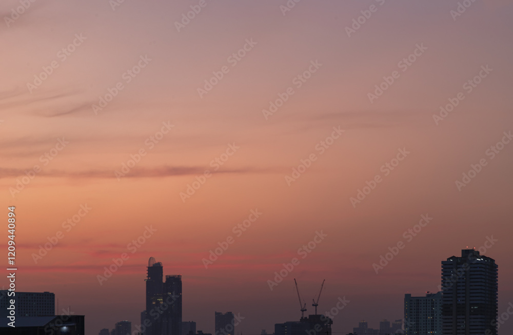 Silhouette view of Skyscrapers and Construction tower crane on buildings with Pastel colored another sky during sunset. use it as your Wallpaper, Poster and Space for text, Selective focus.
