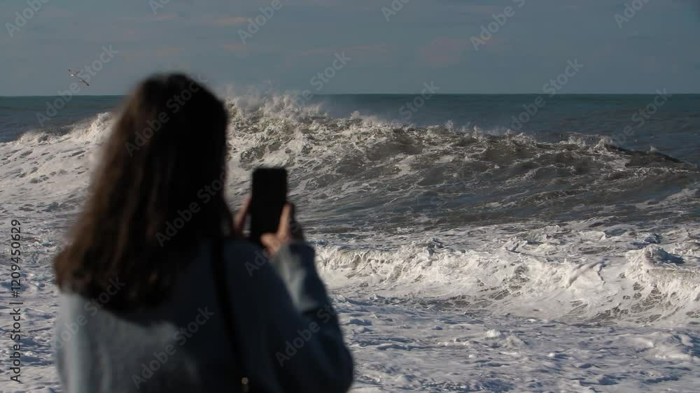 A girl shoots big waves on her phone A girl shoots big waves on her phone