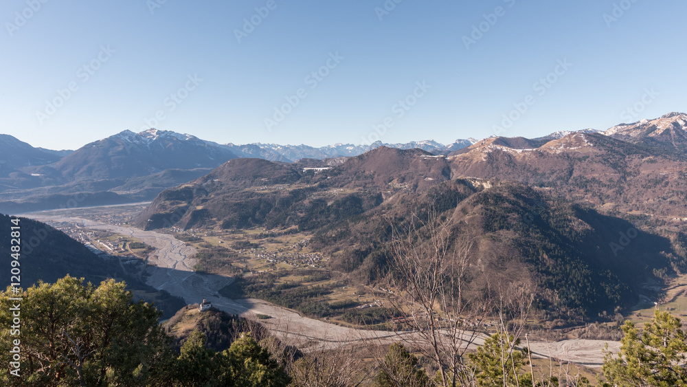Fototapeta premium Panorama of the Carnic mountains from the top of Mount Giaideit, Friulian Alps. Sunny day and view of the Pieve di San Floriano.