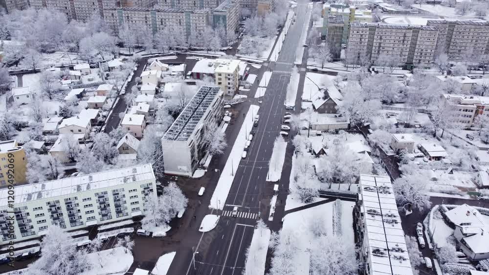 Snowy aerial view of Purvciems, Riga, showcasing a quiet urban winter scene Snowy aerial view of Purvciems, Riga, showcasing a quiet urban winter scene