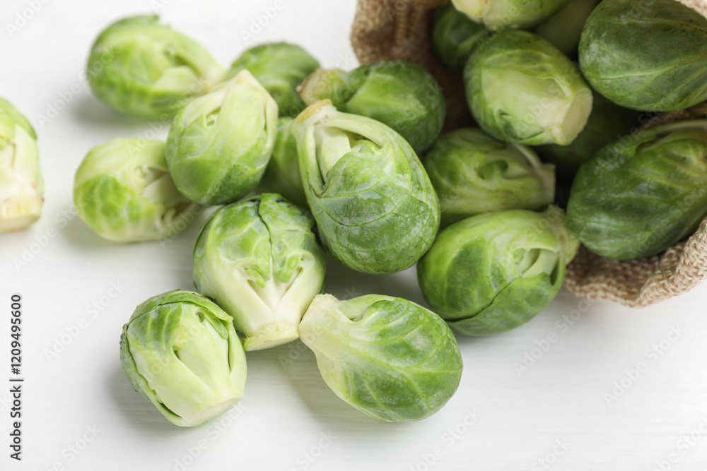 Fresh Brussels sprouts in bag on white table, closeup Fresh Brussels sprouts in bag on white table, closeup