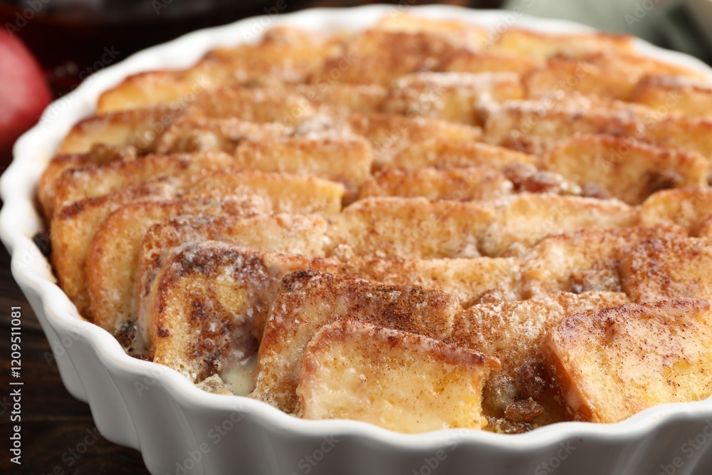 Delicious bread pudding with raisins and cinnamon on wooden table, closeup Delicious bread pudding with raisins and cinnamon on wooden table, closeup