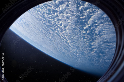 Obraz na płótnie Earth in space station porthole. Spaceship flies near the glowing blue planet Earth, view from the window. Elements of this image furnished by NASA w salonie