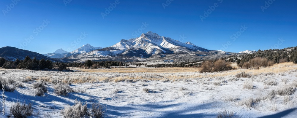 Scenic view of a snowy mountain range with clear skies. Scenic view of a snowy mountain range with clear skies.