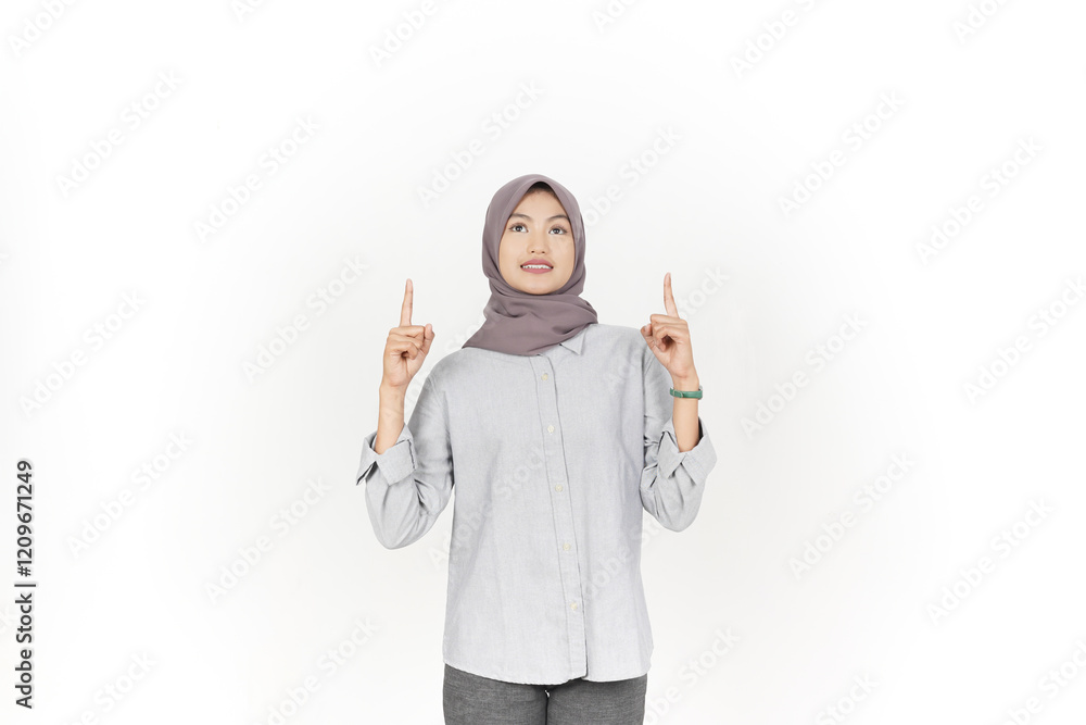 Showing, Presenting and pointing up at copyspace Of Beautiful Asian Woman Wearing Hijab Isolated On White Background Showing, Presenting and pointing up at copyspace Of Beautiful Asian Woman Wearing Hijab Isolated On White Background