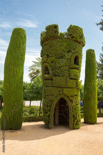 Tower carved in a cypress. It is located in the gardens of the the Castle of the Christian Monarchs (Alcázar de los Reyes Cristianos) located in Córdoba, in Andalusia, Spain. photo