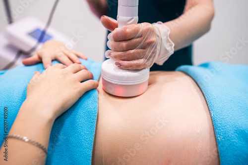 The young woman in the office of the hardware correction to vacuum massage procedure photo