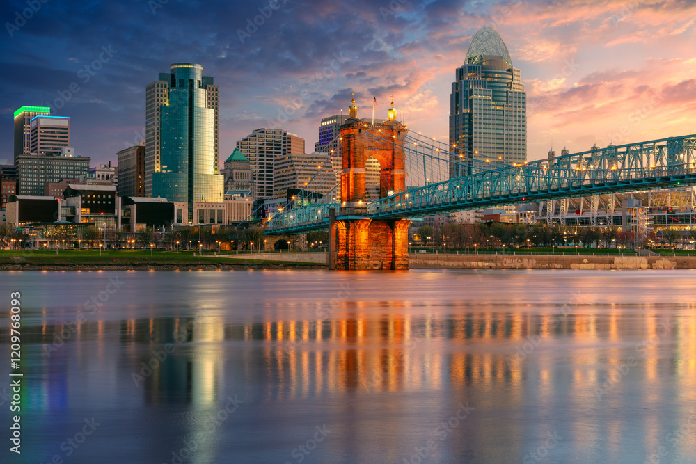 Naklejka premium Cincinnati, Ohio, USA. Cityscape image of Cincinnati, Ohio, USA downtown skyline with the John A. Roebling Suspension Bridge and reflection of the city in the Ohio River at spring sunrise.