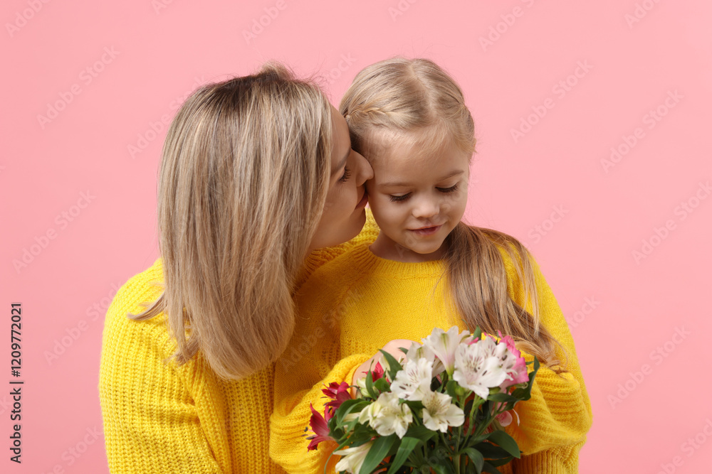 Woman with her daughter and bouquet of alstroemeria flowers on pink background. Mother's Day celebration Woman with her daughter and bouquet of alstroemeria flowers on pink background. Mother's Day celebration