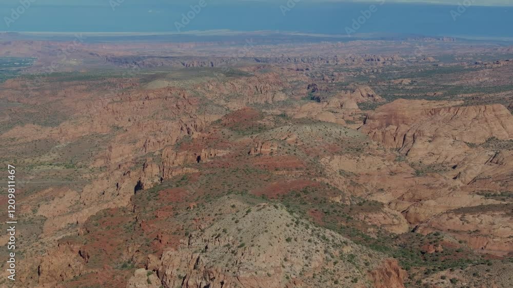 Moab's red desert landscape with rugged canyons under a clear sky, aerial view Moab's red desert landscape with rugged canyons under a clear sky, aerial view