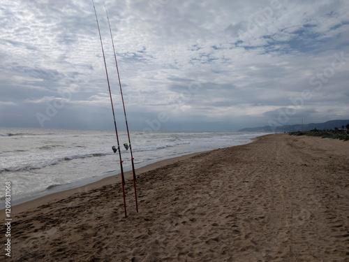 Cañas de pesca en la arena photo