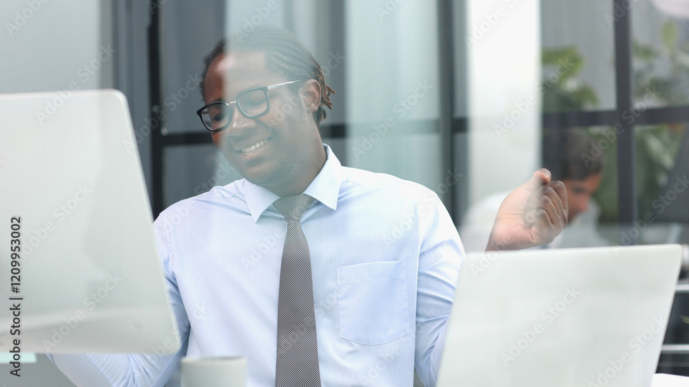 Fototapeta premium portrait of a man at his workplace at the table in front of the computer smiling