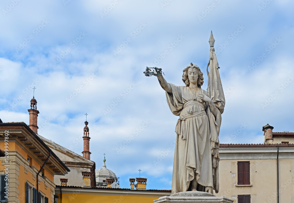 Obraz premium The marble monument to Beautiful Italy of Bell'Italia on Piazza della Loggia with slightly clouded blue sky on a summer day in Brescia. Selective focus