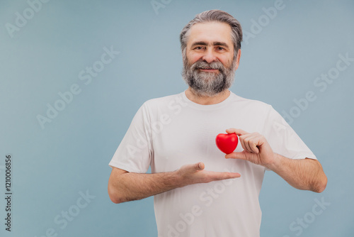 Canvastavla Smiling Senior Man Holding Small Red Heart Promoting Healthcare and Cardiology A