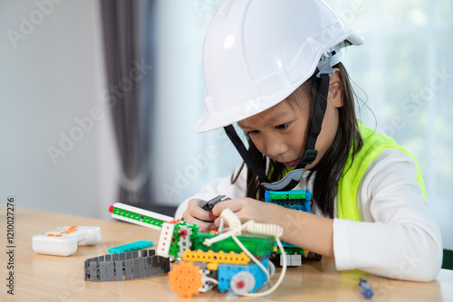 Young girl working on a robot design in Robotics programming class. STEM education using constructor blocks and laptop, Technology educational development for school kids photo