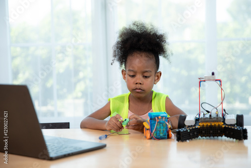 Young girl working on a robot design in Robotics programming class. STEM education using constructor blocks and laptop, Technology educational development for school kids photo