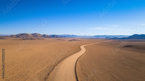 Aerial drone view of desert landscape with sand dunes and long road