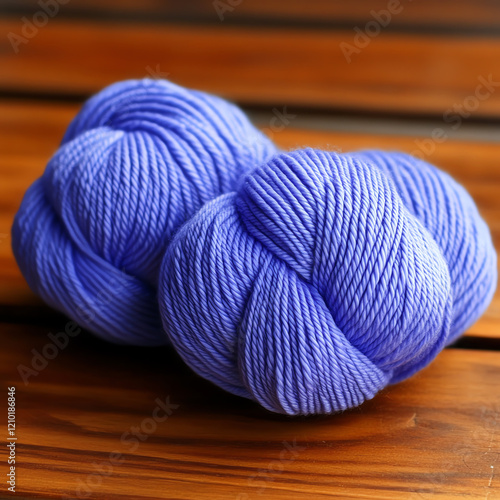 Soft, vibrant purple yarn bundles neatly arranged on a wooden surface, perfect for knitting or crafting projects. photo