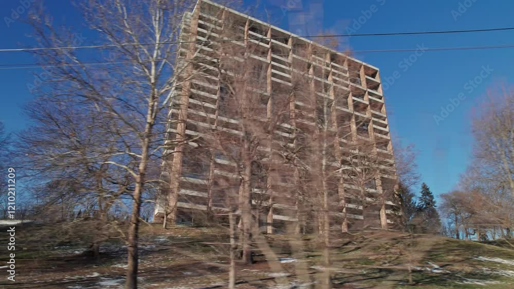 Cold, isolated, and decayed apartment building complex with multiple stories and units during winter weather day in the United States on a January day after a icy and snow storm Cold, isolated, and decayed apartment building complex with multiple stories and units during winter weather day in the United States on a January day after a icy and snow storm