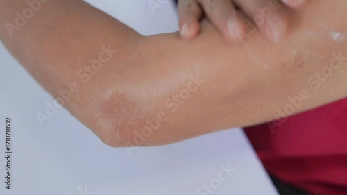 Footage of applying body lotion to the arm to nourish the skin to be moist and radiant. Video clip, lifestyle, health care, elderly age. Skin care to have aura, using body cream