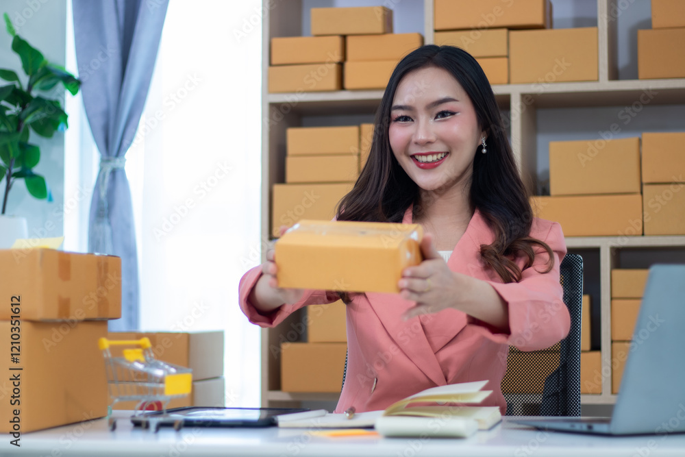 Beautiful girl working in online sales Business owners using tablets or laptops check online orders and pack products for delivery to customers. ecommerce online shopping Beautiful girl working in online sales Business owners using tablets or laptops check online orders and pack products for delivery to customers. ecommerce online shopping