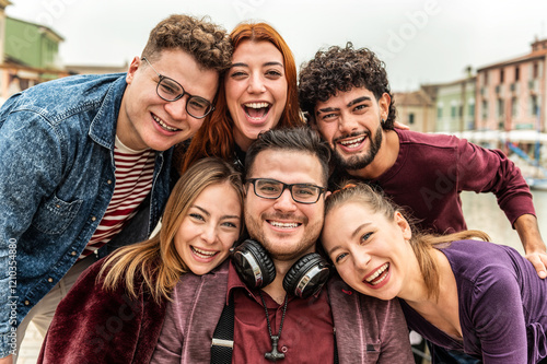 Multi ethnic twins guys and girls taking selfie picture outdoors - Millennial people having fun on city street - International students smiling together at camera - Youth culture and community concept